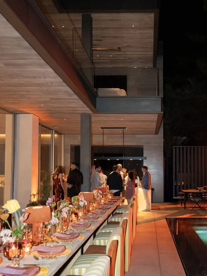 Night poolside reception with candlelit table and guests